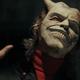 Ethan Hawke wears a white mask with horns in a scene from The Black Phone.